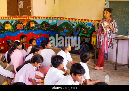 Woman teaching at mixed school in Asde Village Mulshi Valley Paud Maharashtra India Stock Photo