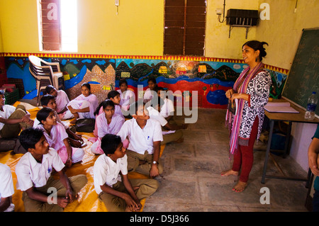 Woman teaching at mixed school in Asde Village Mulshi Valley Paud Maharashtra India Stock Photo