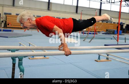 86-year-old Johanna Quaas, the world's oldest gymnastd, is pictured during her weekly training on the bars in Halle, Germany, 06 November 2012. The agile gymnast, whose birthday is on 20 November, does sport acitivities every day and still participates in competitions. As the oldest active gymnast, she is listed in the Guinness Book of World Records. Photo: Waltraud Grubitzsch Stock Photo