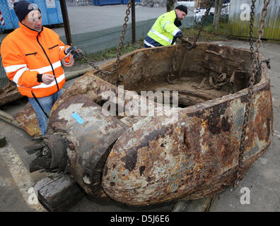 Remnants of a Soviet tank, that were found during construction works in November 2011 and that were storaged by a weapons and ammunition disposal service, are loaded to a location in Rostock, Germany, 16 November 2012. After disposing a granade within the tank, the Soviet T34 tank, that was probably destroyed on 01 May 1945 during the demolition of a bridge, shall be presented in a Stock Photo