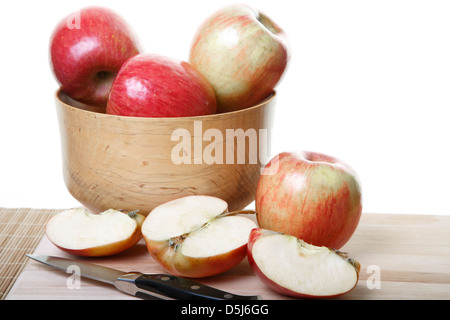 Apples in a wood bowl and on cutting board with some cut in half Stock Photo