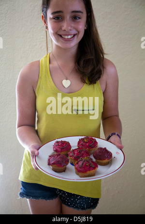 Girl With Plate of Cupcakes She Baked Stock Photo