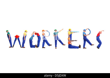 Group of young people wearing different color uniforms and hard hats forming Workers word - isolated on white background Stock Photo