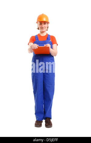 Female site manager wearing blue jumpsuit taking notes on notepad over white Stock Photo