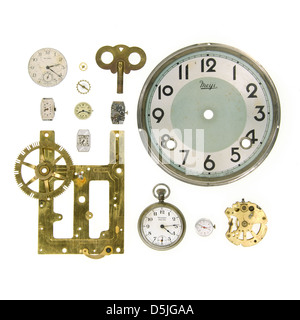 Clock parts, clock faces, and watch mechanisms on a white background Stock Photo