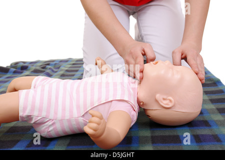First aid instructor showing how to position infant head before proceeding to mouth-to-mouth resuscitation Stock Photo