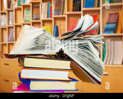 Open book lying on a stack of books Stock Photo
