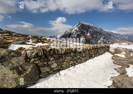 Snow during April at Cwm Idwal, a valley in the Glyderau range of mountains in northern Snowdonia, north Wales. Stock Photo