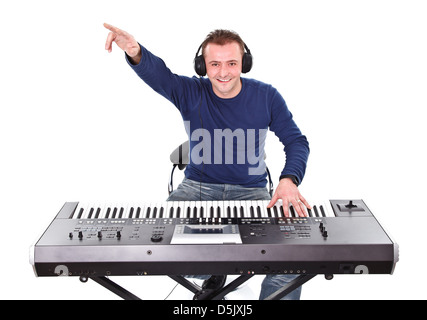 Portrait of a young smiling man with headphones and keyboard Stock Photo