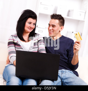 Young couple using credit card to shop from the internet Stock Photo