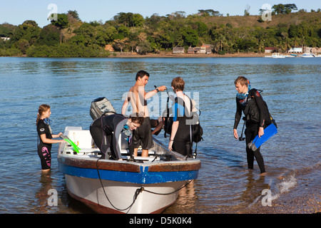Madagascar, Nosy Be, Marodokana, Operation Wallacea diving students boarding dive boat Stock Photo