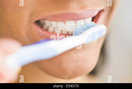 Close-up of woman brushing teeth Stock Photo