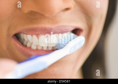 Close-up of woman brushing teeth Stock Photo