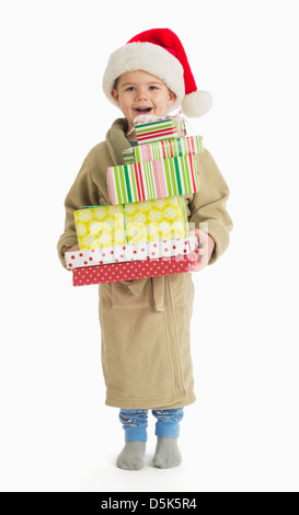 Portrait of boy (4-5) carrying christmas presents Stock Photo