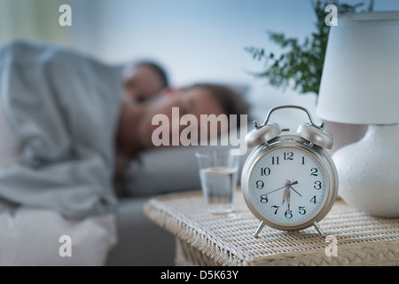 Alarm clock in bedroom Stock Photo