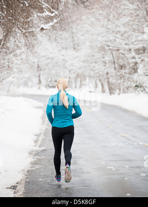 USA, Utah, Salt Lake City, Woman jogging in winter Stock Photo