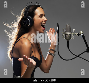 Studio shot of singing rockstar Stock Photo