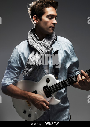 Studio shot of man playing electric guitar Stock Photo