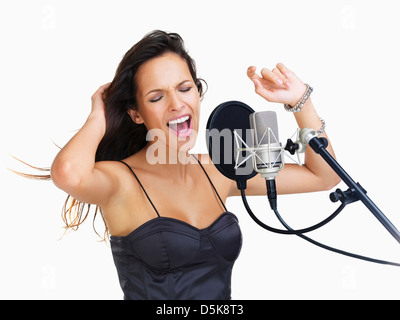 Studio shot of singing rockstar Stock Photo