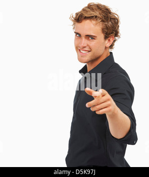 Studio Shot, Portrait of young man pointing Stock Photo