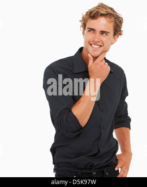 Studio Shot, Portrait of young man standing, hand on chin Stock Photo