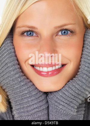 Studio portrait of young woman wearing gray sweater Stock Photo