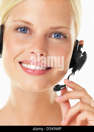 Studio portrait of young woman wearing headset Stock Photo