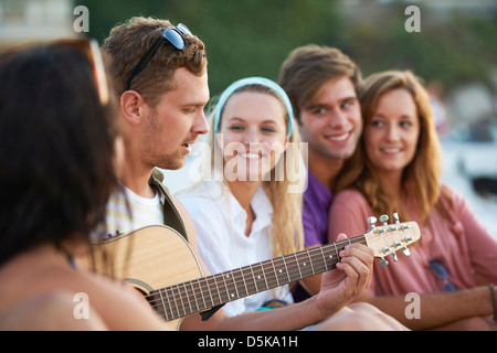 Group of friends relaxing at beach Stock Photo