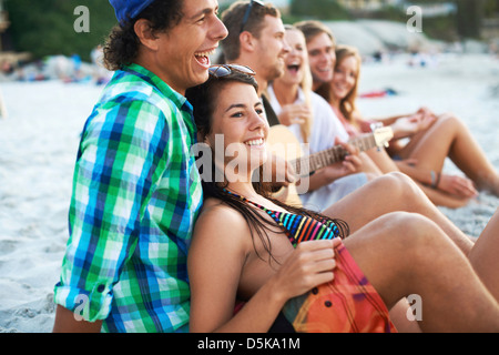 Group of friends relaxing at beach Stock Photo