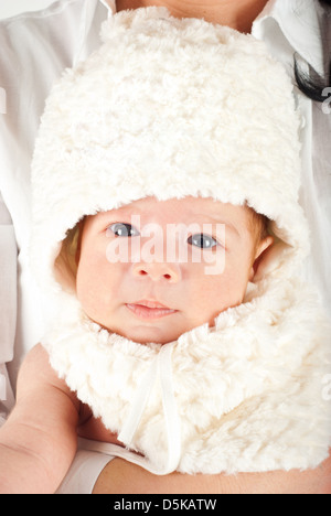 Beauty newborn baby boy with bunny cap in his mother arms Stock Photo