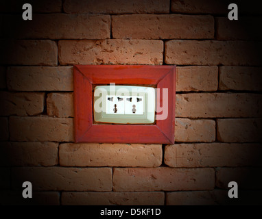 electrical outlet on a wall of red brick. Stock Photo