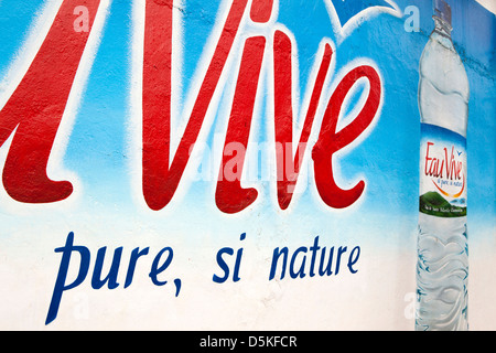 Madagascar, Nosy Be, Hell-Ville, Eau Vive bottled water advertisement hand painted on wall Stock Photo