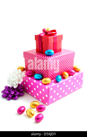 Pink gift boxes with chocolate eggs isolated over white Stock Photo