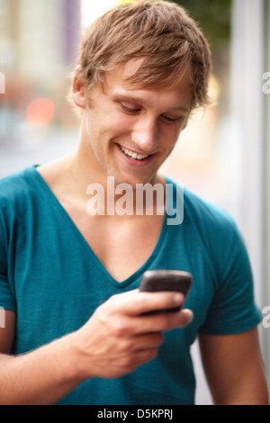 Portrait of young man using mobile phone Stock Photo