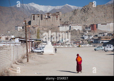 A monk walks towards the old Palace in the Himalayan mountain town of Leh, Ladakh, Jammu and Kashmir. India. Stock Photo