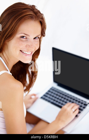Studio shot of woman using laptop Stock Photo