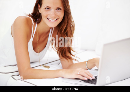 Studio portrait of woman using laptop Stock Photo