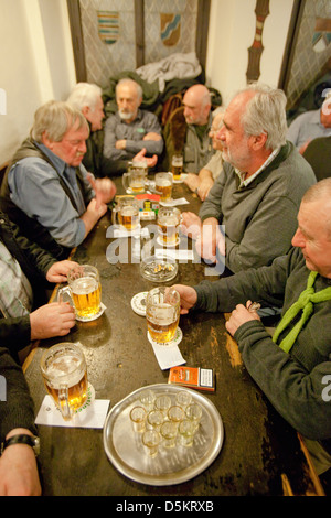 Prague - friends in a traditional Czech pub drinking beer. Stock Photo