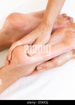 Hand massaging feet Stock Photo