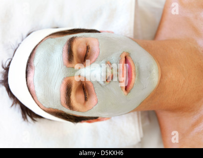 Man with face mask relaxing in spa Stock Photo