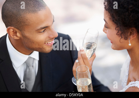 Newly wed couple drinking champagne Stock Photo