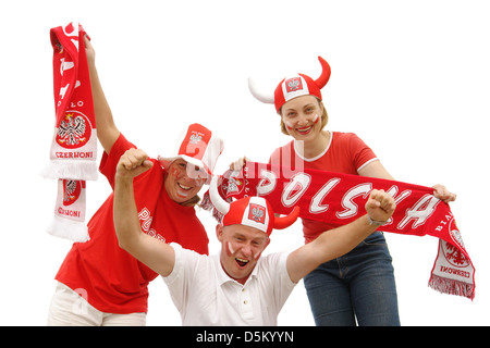 Three young Polish soccer fans dressed in Polish national color t-shirts, caps and scarfs cheering on over white background Stock Photo