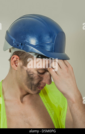 Closeup of a stressed collar worker with a headache. Stock Photo