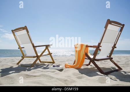 Sun chairs on sandy beach Stock Photo