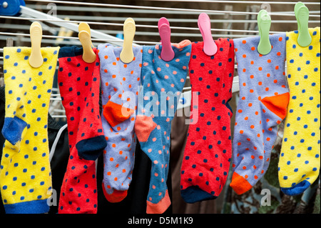 Colourful socks hanging on the washing line Stock Photo