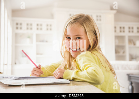 Girl (6-7) doing homework Stock Photo