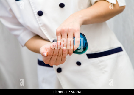 Young woman doing hot stone massage, shallow focus Stock Photo