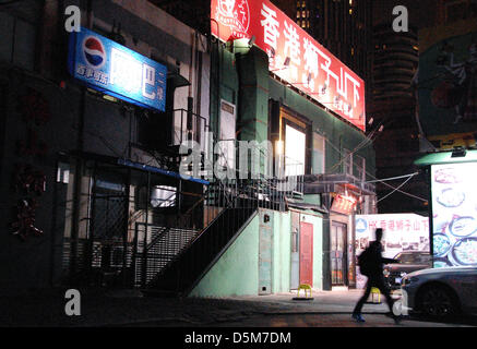 A young man walks past the internet cafe of owner Ding Dang in Beijing, China, 02 April 2013. According to a statistic from the Chinese government, China has about 560 million internet users. More than 60 percent of them play games regularly online. Photo: Stephan Scheuer Stock Photo