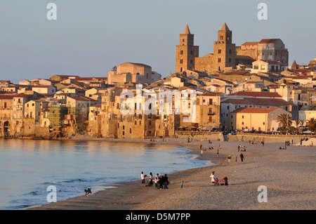 Beachgoers in the historic town of Cefalu on the coast of Sicily, Italy. Stock Photo