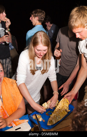 Madagascar, Nosy Be, Marodokana, Operation Wallacea students sharing breadfruit Stock Photo